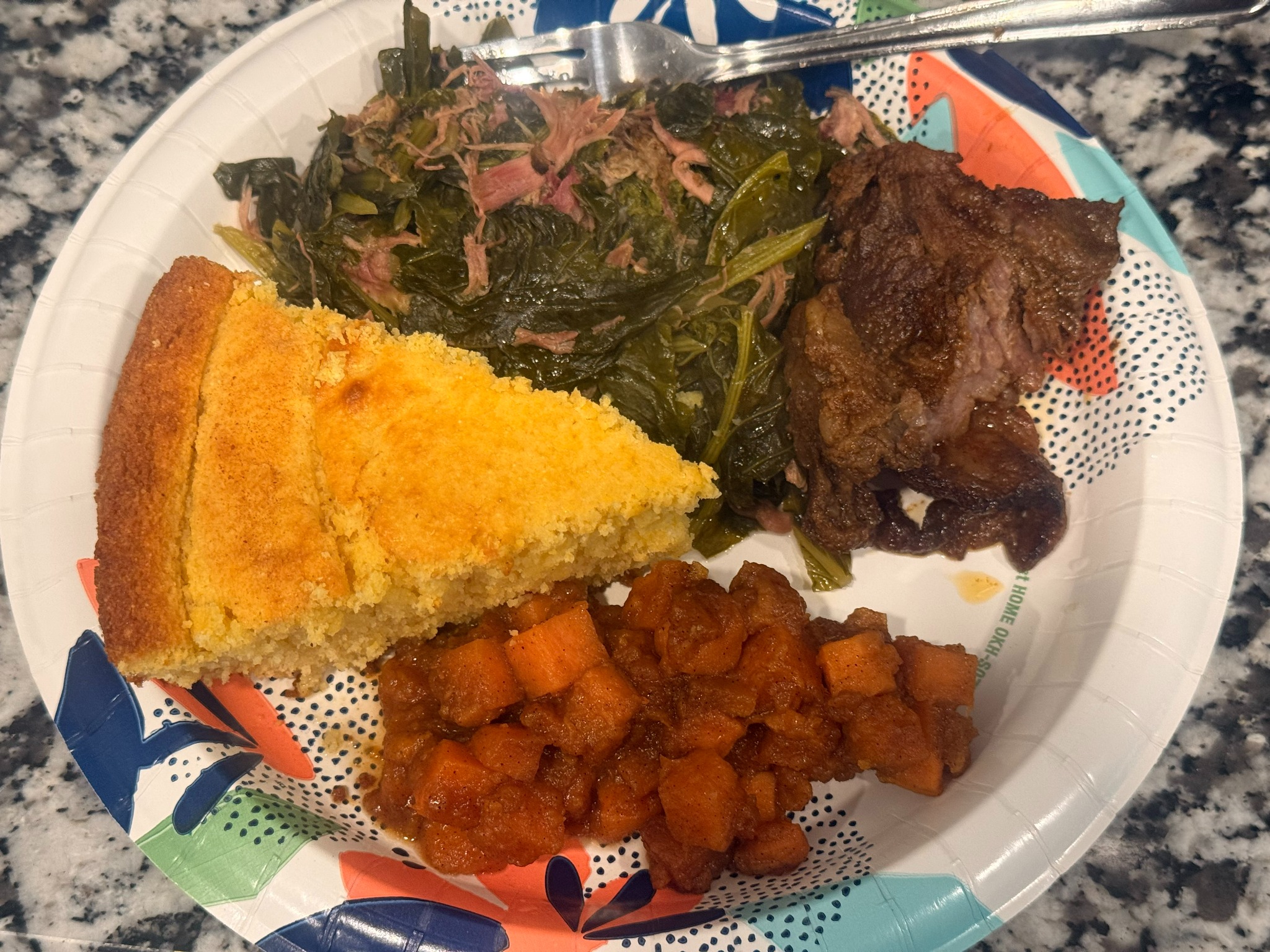 Southern plate with greens, cornbread, beef, and yams